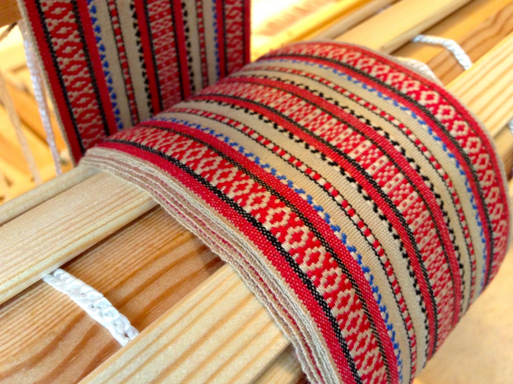 Handwoven rosepath band on cloth beam