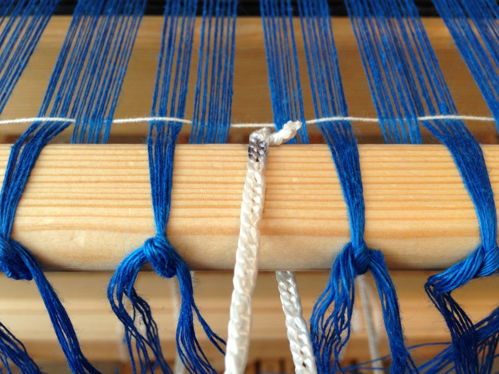 Linen warp is tied on to front bar, with leveling cord in place.