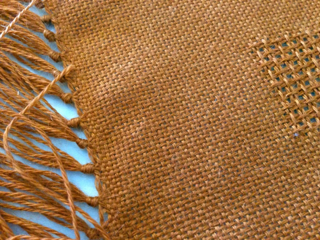 Tying fringe on handwoven lace weave alpaca shawl.