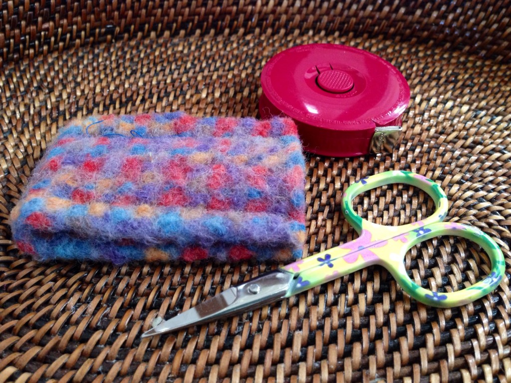 Small pretty scissors and inkle-woven felt sheath.