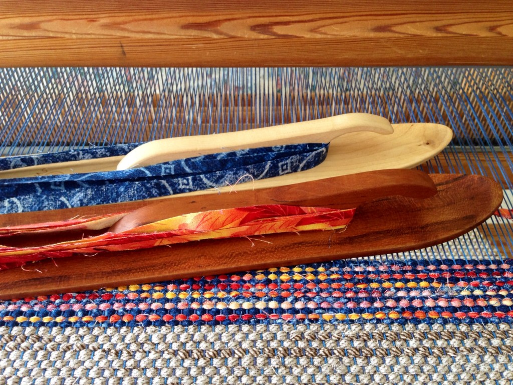 Weaving rag rugs with handmade cherry ski shuttle.