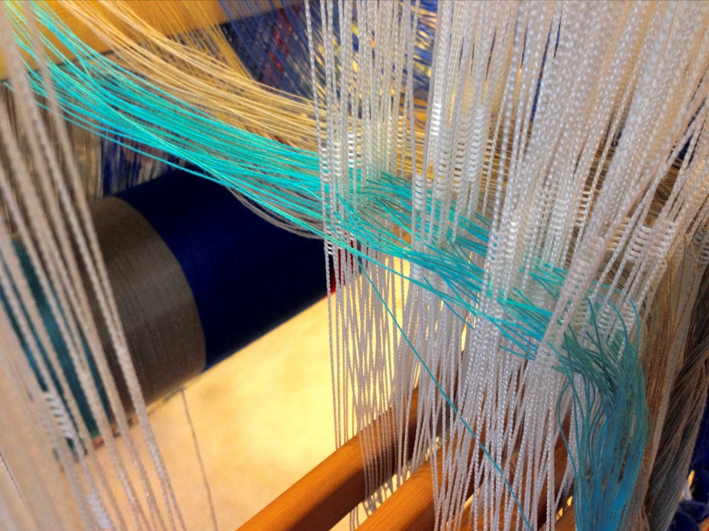 Threading Texsolv heddles for cotton hand towels.