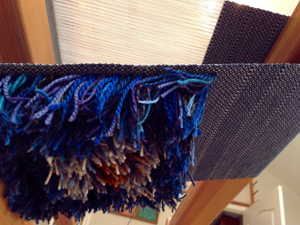 Pillow top with rya knots, viewed from under loom, looking up. Karen Isenhower