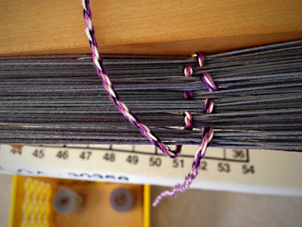 Looking down at the counting string, measuring warp on the warping reel.