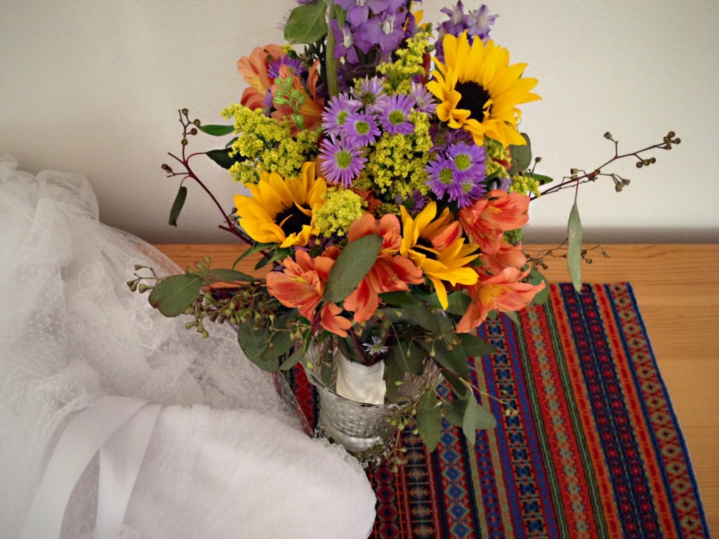 Bride's wedding dress and bouquet is displayed on bound rosepath by her mother and hope chest built by her father.