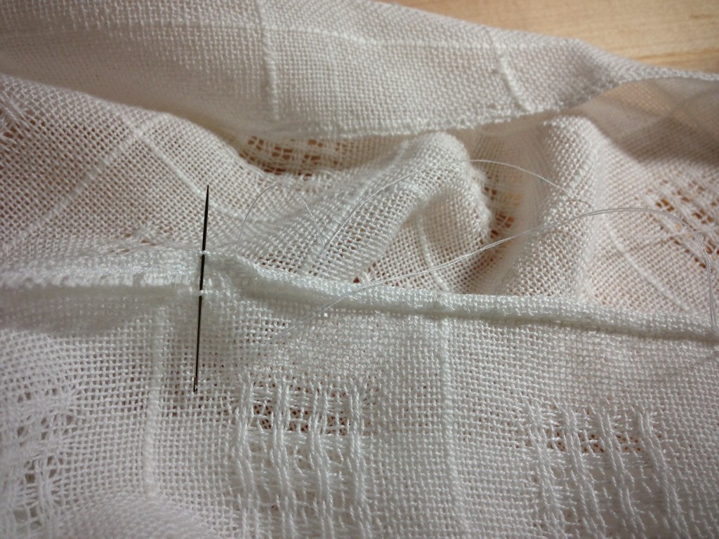 Hand-stitched rolled hem on handwoven Swedish lace cloth.