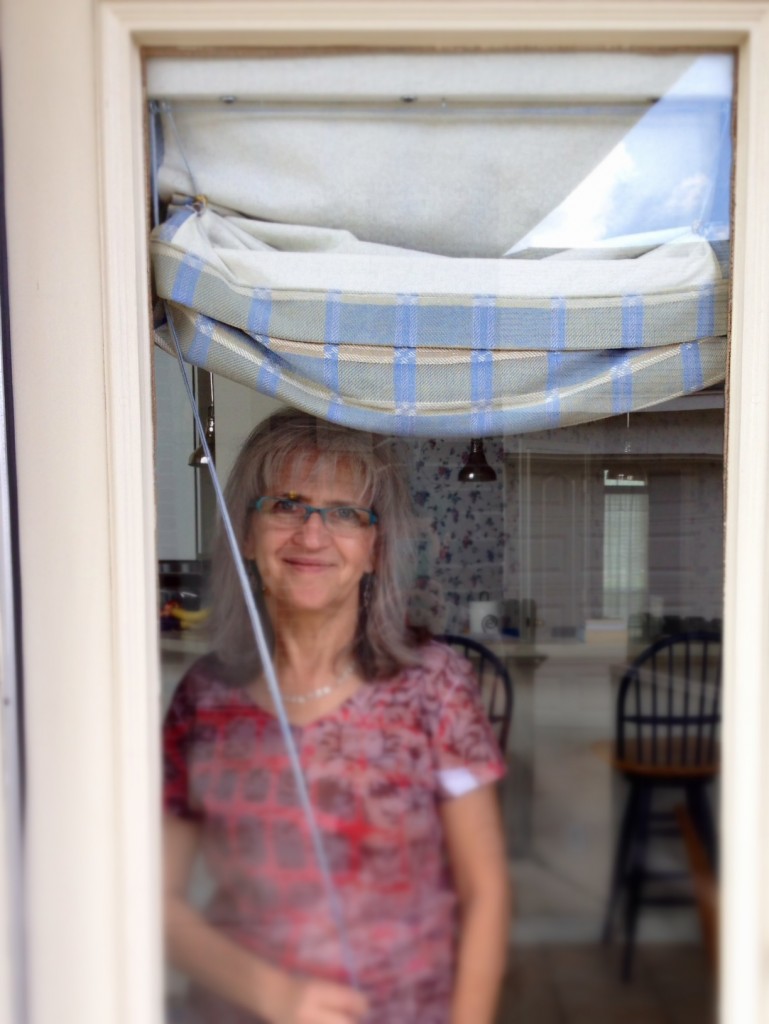Opening the handwoven Roman shades. Please come on in!