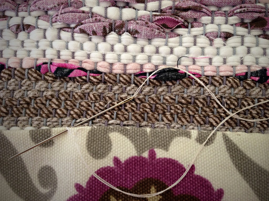 Last step in tutorial for making bound hem on rug.