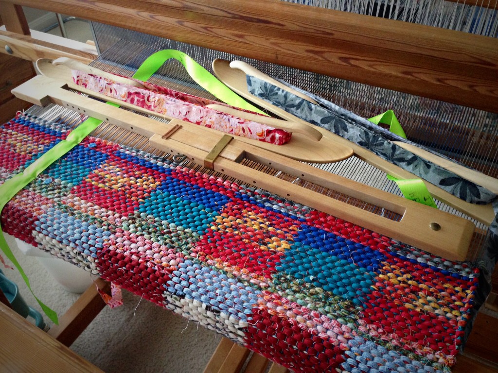 Weaving sunsets into a rag rug on the loom.
