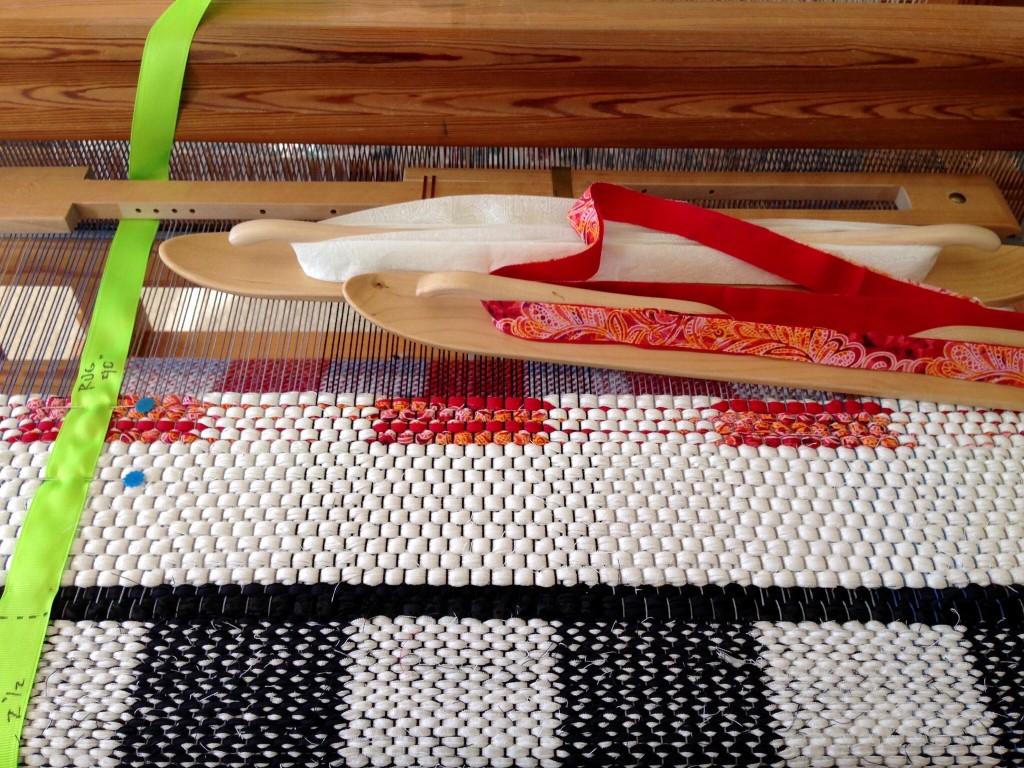 Black and White and Red rag rug on the loom.