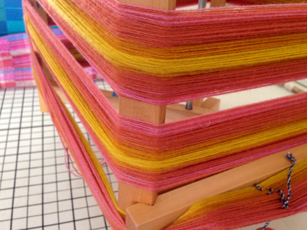 Winding wool warp on warping reel.