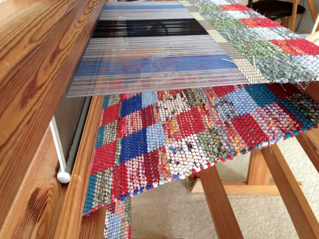 Double-binding rag rug on loom.