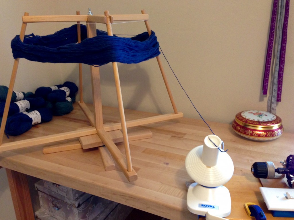 Winding wool skeins into balls using old Beka yarn swift.