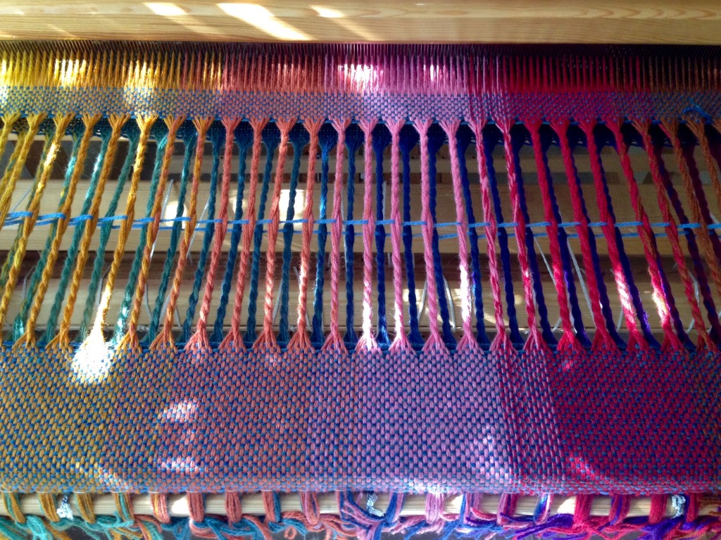 Blanket fringe is twisted on the loom.