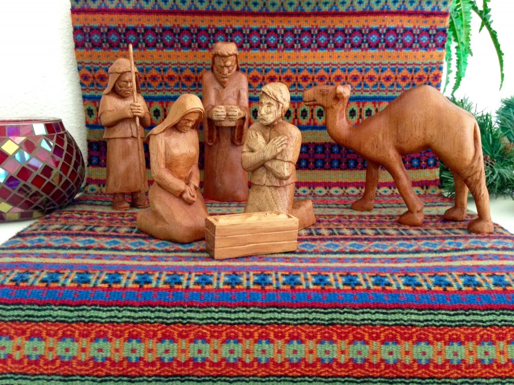 Hand-carved Nativity on handwoven bound rosepath. The Isenhowers.