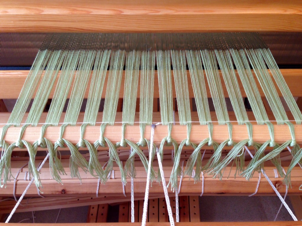 Cotton warp for scarves is tied on.