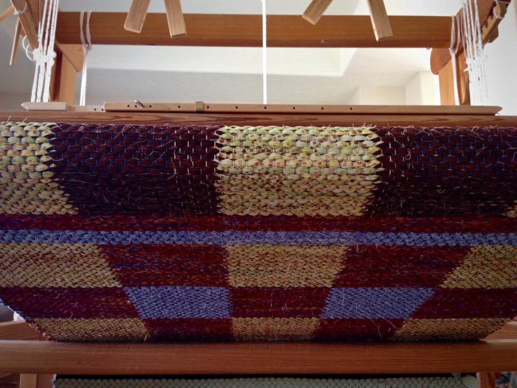 Patterned rag rug on the loom.