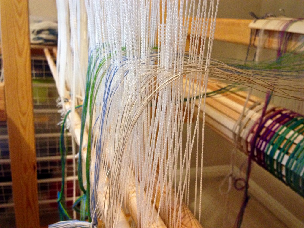 Threading the loom with linen.