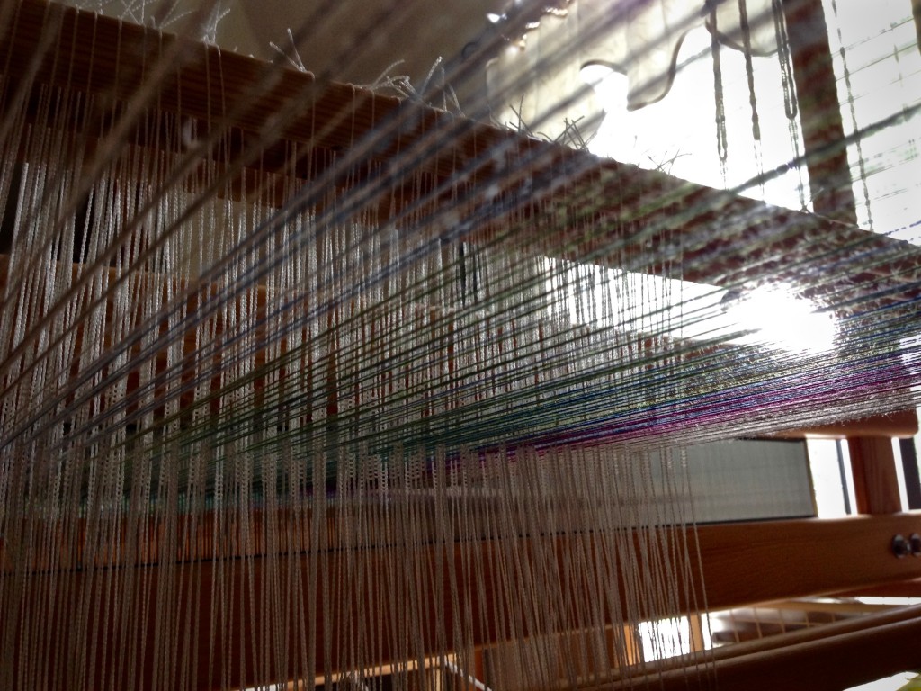 Tying up treadles in the "playhouse" under the warp.