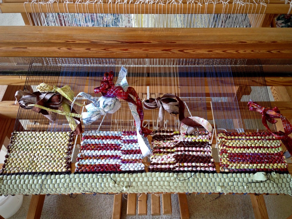 Miniature rag rugs, side by side.