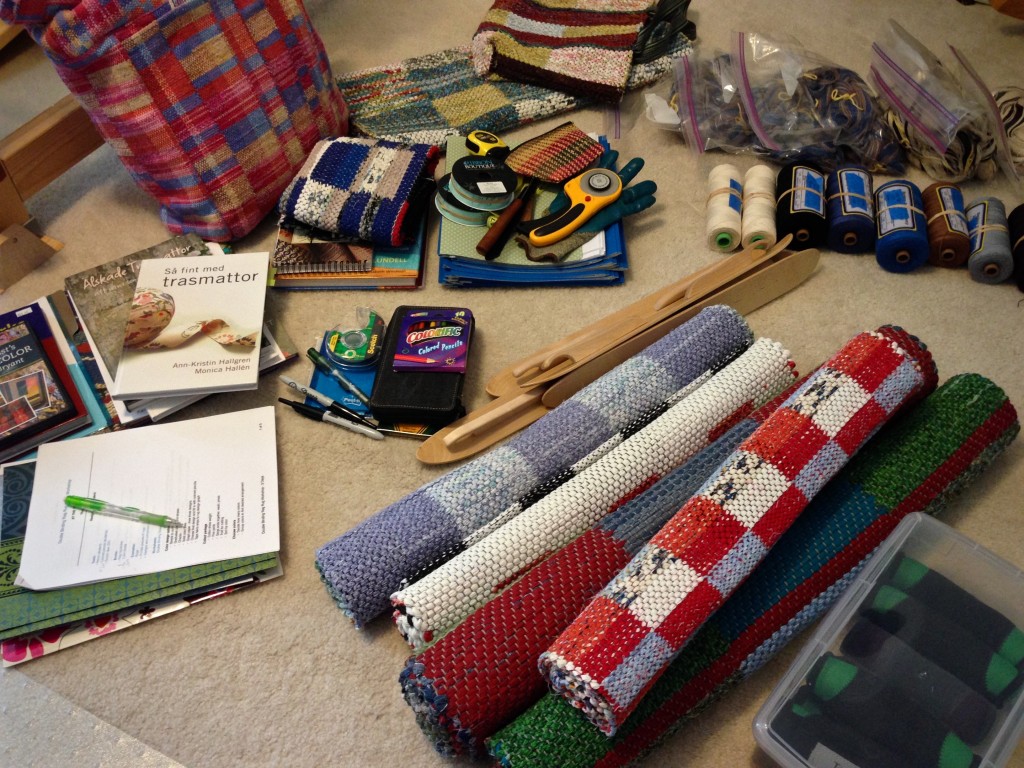 Gathering supplies to teach rag rug weaving class.