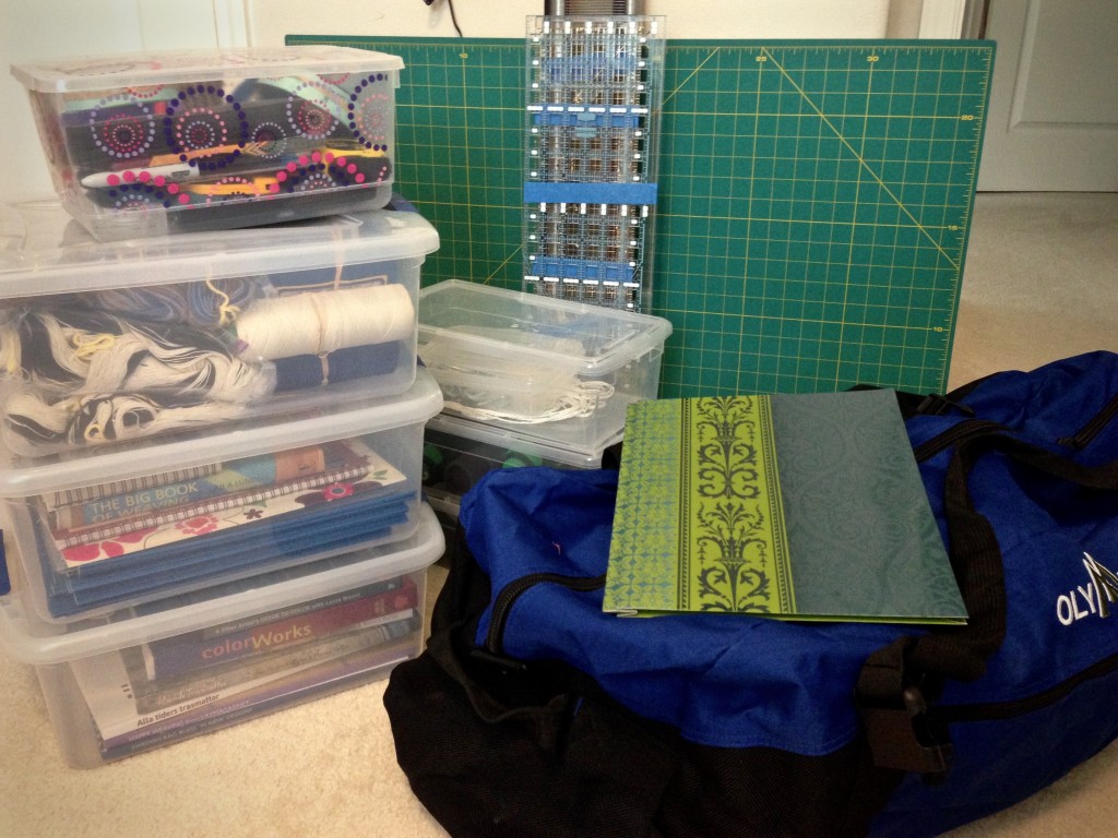 Workshop supplies are stacked in plastic tubs.