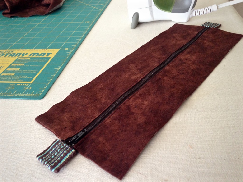 Adding zippered top to handwoven bag.