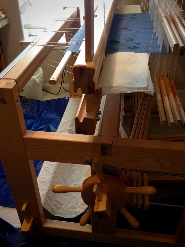 Painting and stamping warp on the loom.