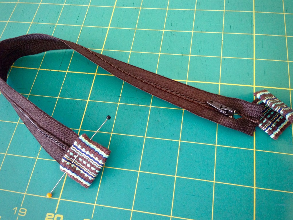 Preparing zipper to add to bag.