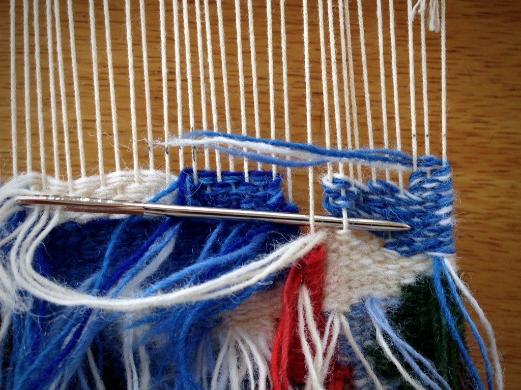Weaving small tapestry from the back.
