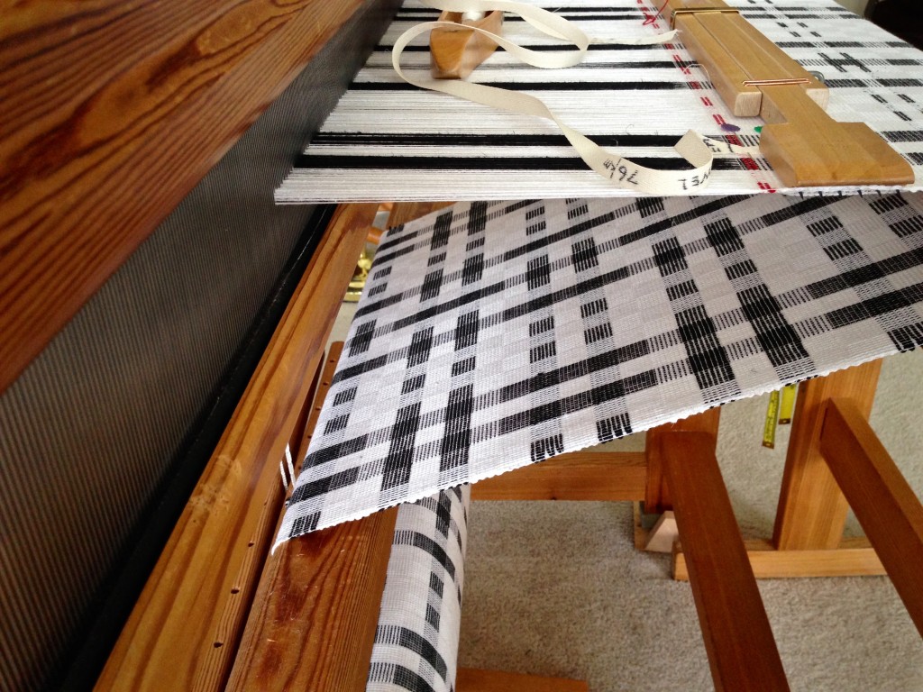 Temple in place for weaving black and white cottolin towels.