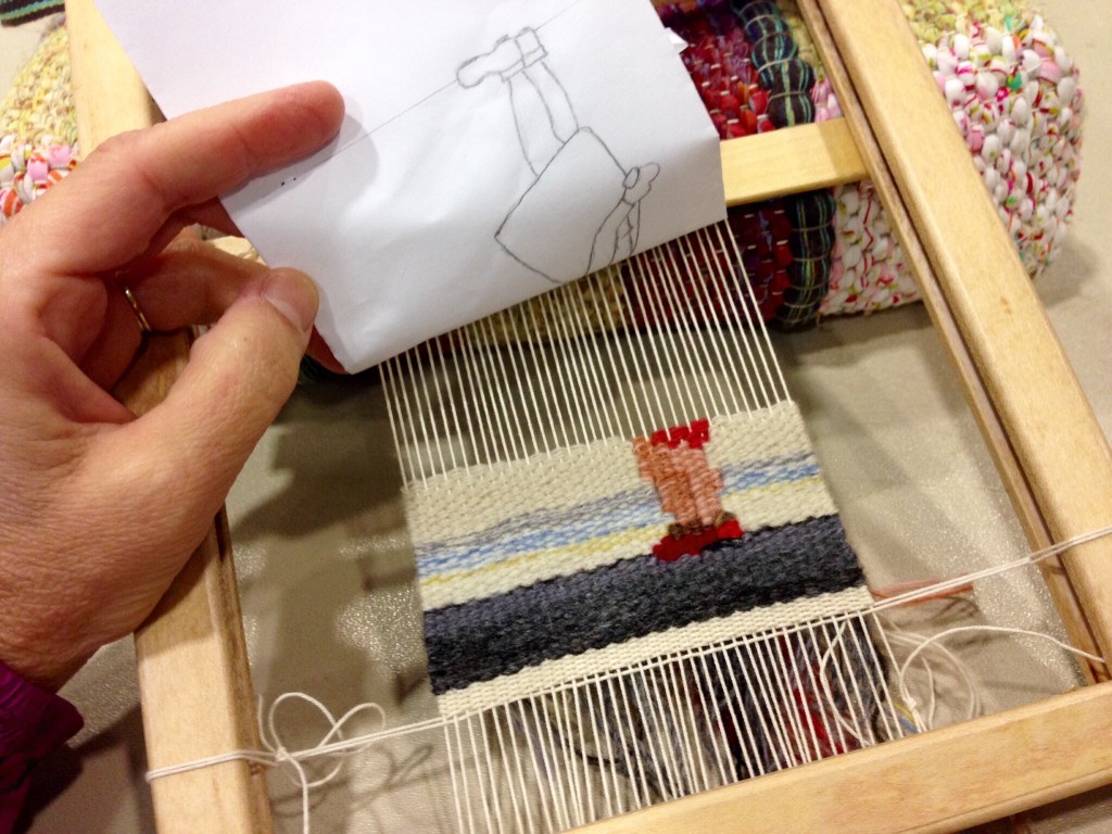 Small tapestry on portable frame loom.
