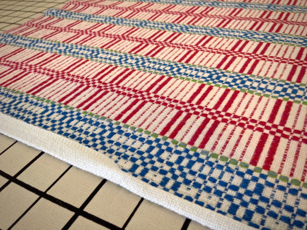 Folding edge under for hemming. Handwoven table squares.