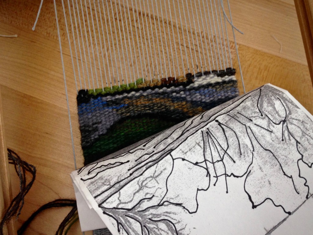 Weaving small tapestry on travel loom.