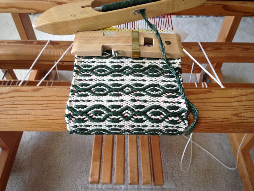 Mug rug being woven with string yarn. Customized mini temple.