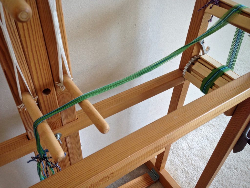 Warping the Glimakra band loom.