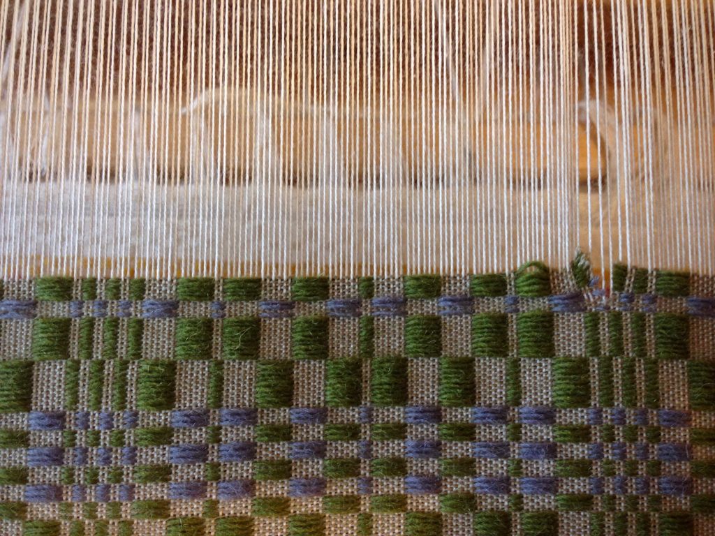 Weft threads are carefully snipped back to point of error.