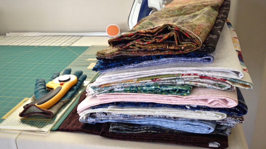 Piles of fabric for making patterned rag rugs.