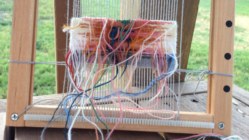 Weaving from the back on small travel tapestry frame loom.