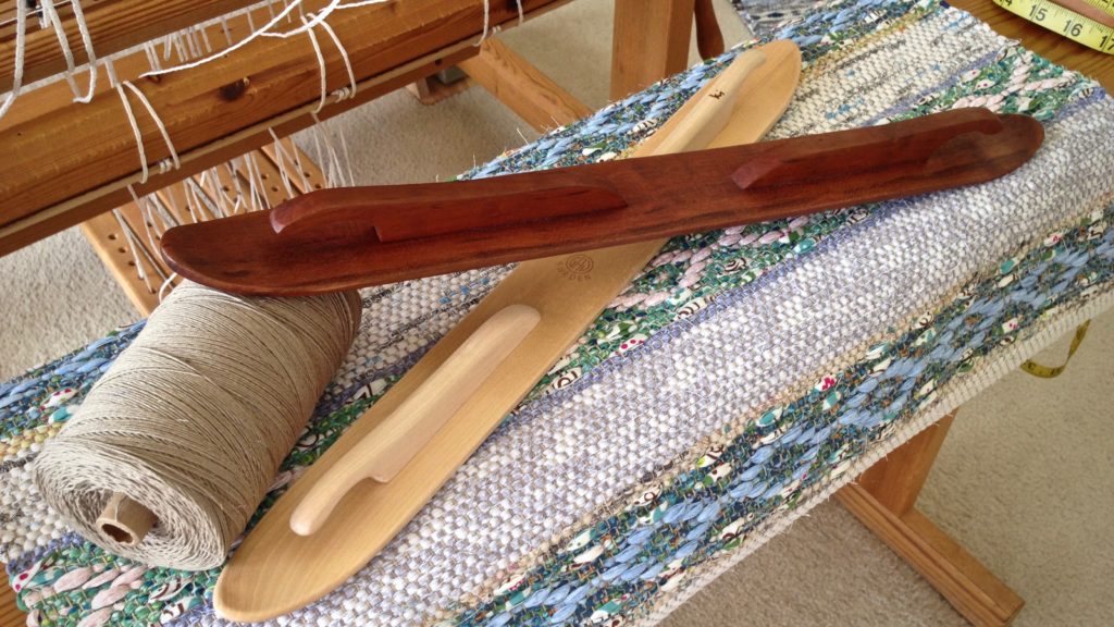 Hand crafted cherry wood ski shuttle, and rosepath rag rug just off the loom.