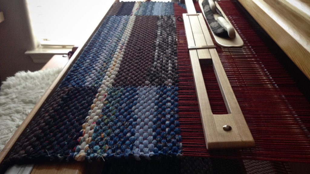 Double binding rag rug. Red warp shows up as little red spots.