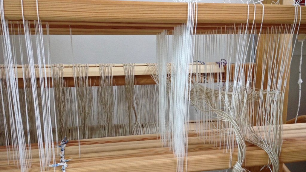 Threading heddles on eight shafts.