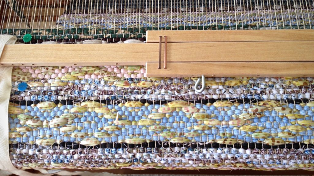 Classic rosepath motif in a rag rug on the loom.