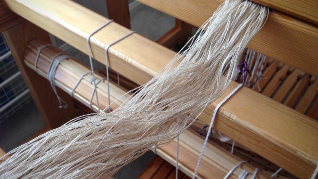 Preparing to beam a linen warp.