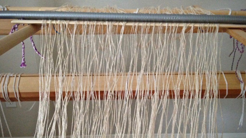 Dressing the loom with a linen warp.