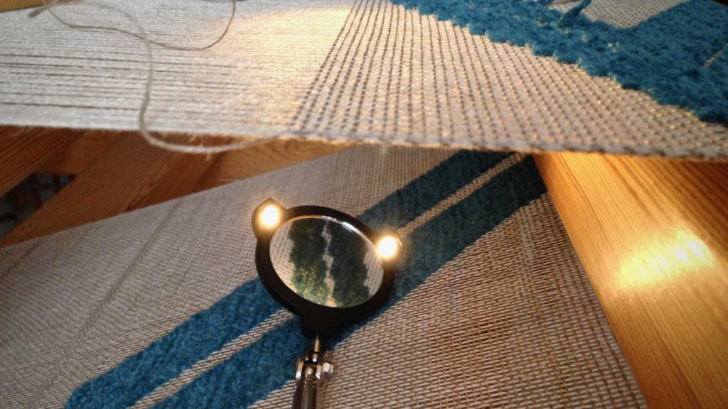 Lighted mirror extends to inspect underneath the cloth.