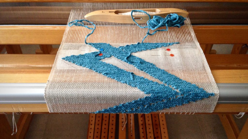 Transparency weaving on the loom, with buckram cartoon.