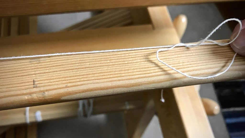 Finishing the knot for the leveling string.