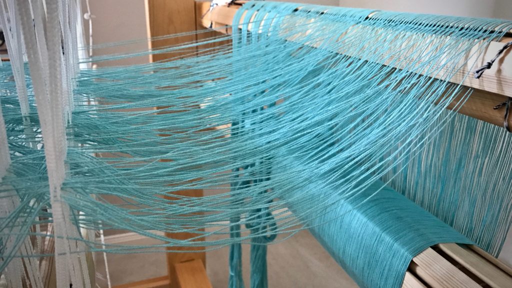 Aquamarine cotton. Threading my Glimakra Standard loom.