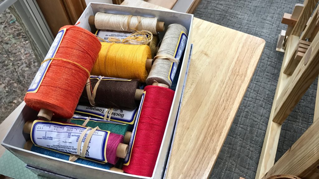 Box of colorful linen for a tapestry project!